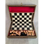 A small wooden chess set in marquetry box/board