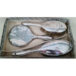 A silver dressing table set of 3 comprised of 2 hair brushes and mirror, hallmarked for 1915,