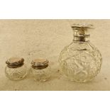 A silver topped cut glass scent bottle - AF and a pair of silver topped cut glass jars, hallmarked