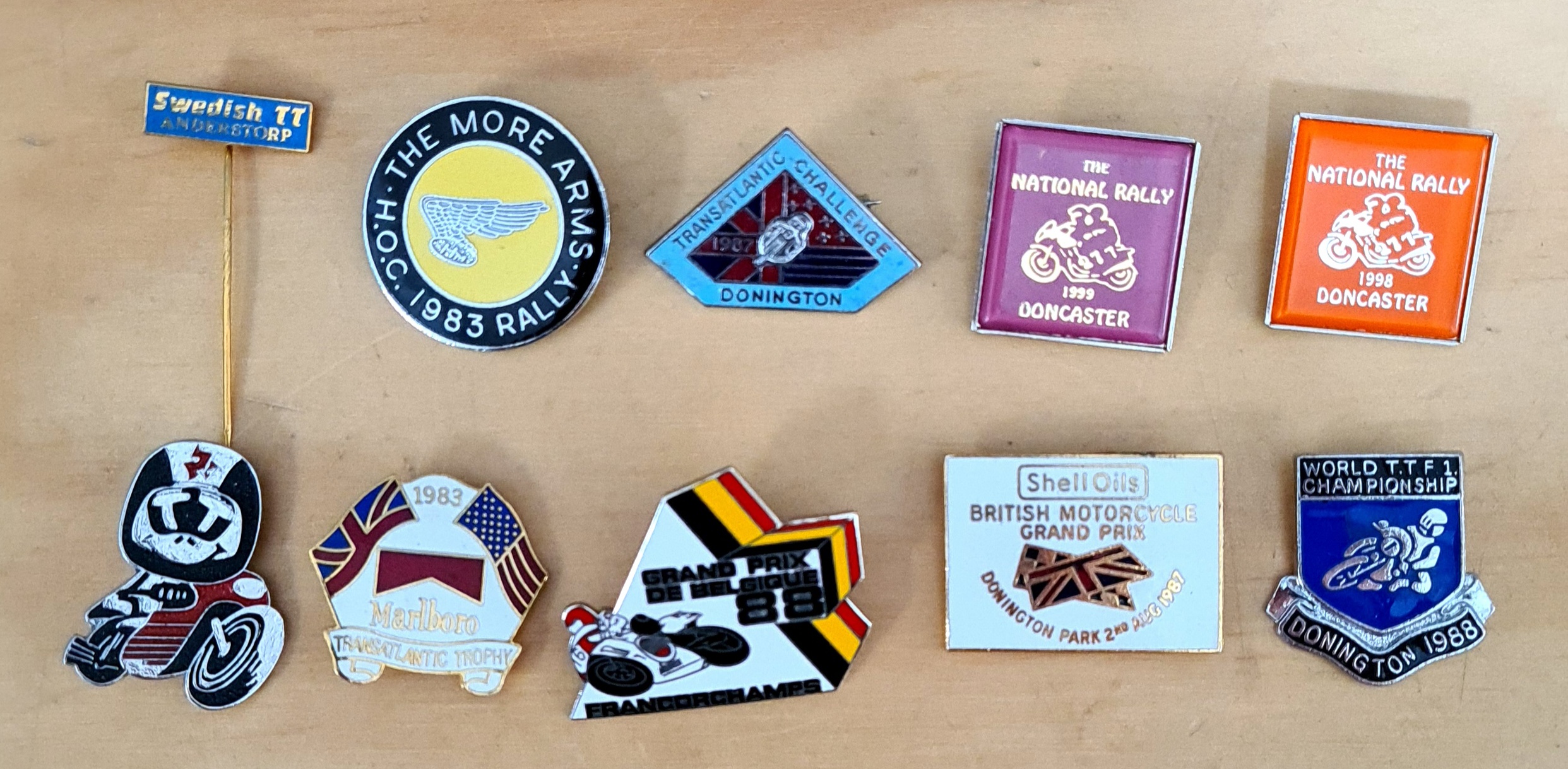 A group of 10 motorcycle pin badges