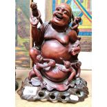 A Chinese carved wooden buddha on stand, height 27cm.