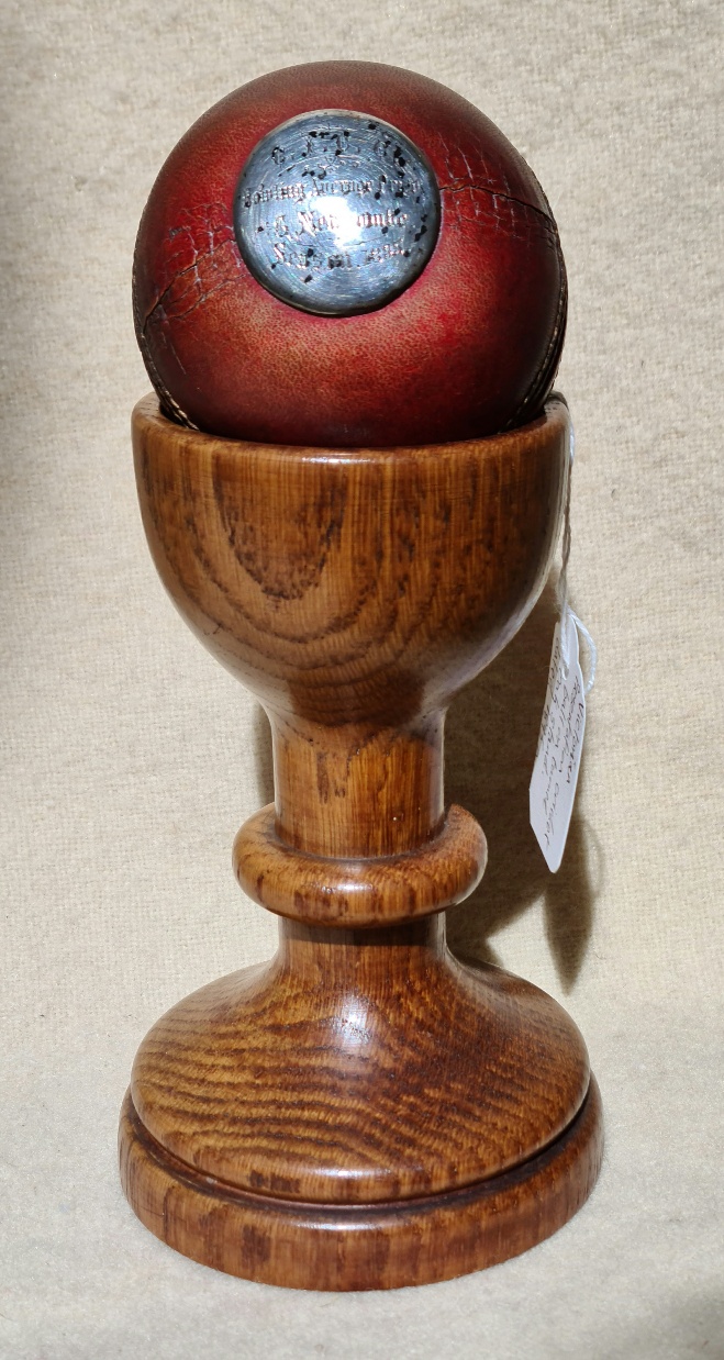 A Victorian cricket trophy, mounted ball on stand.