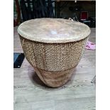 A large African drum bound in Djembe cow hide, from Senegal, 58cm top diameter, 63cm height.
