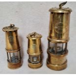 An unusual set of 3 graduated brass miner's lamps.