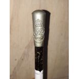 An ebonised George VI swagger stick with descriptive metal top.