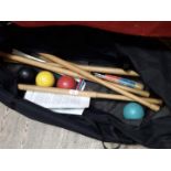 A vintage croquet set with bag.