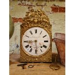 A French gilt wall clock, having enamelled dial, with key.