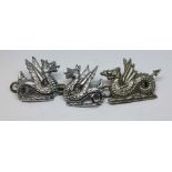 A set of three Midland Railway Wyvern cap badges.