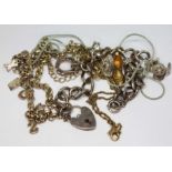 A silver charm bracelet and other items of jewellery.