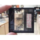 A wooden box containing approx. 58 glass slides, 3" by 3", 38 of prehistoric cave paintings,