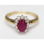 A diamond and ruby cluster ring, marked '375', gross wt. 2.6g, size O. Condition - evidence of