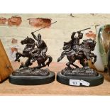 Two bronze effect cast metal warriors.