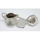 A group of silver items including a small ladle spoon, a small jug and a vesta case, gross weight