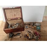 An old wooden box containing costume jewellery and collectables to include "The Metropolitan"