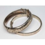 A hallmarked silver bangle and another marked '925', gross wt. 33.8g.