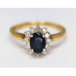 A diamond and sapphire cluster ring, marked '375', gross wt. 3.4g, size O. Condition - evidence of