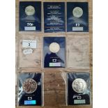 A sleeve of collectable UK coins including £5 coins, £2 coins and Isaac Newton 50p.