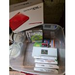 A Nintendo DS Lite, red, in box with handbooks, charger, etc plus additional 5 DS games including