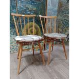 A pair of Ercol light beech and elm 'All Purpose Chairs' model 391.