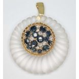 A contemporary diamond, sapphire and rock crystal quartz pendant, formed from a gadrooned outer ring