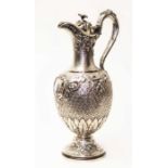 A Victorian Scottish cast silver claret jug with hinged lid, loop handle, floral finial of grape and