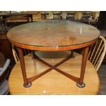 A mid 20th century Danish style round teak coffee table with x-frame base.