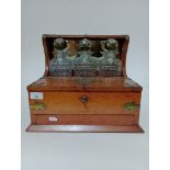 A Victorian oak and brass mounted tantalus with three cut glass decanters.