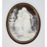 A shell cameo brooch, the oval cameo carved in relief depicting mother and child feeding swans,