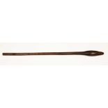 A tribal hardwood club or throwing stick, elongated head and tapered shaft, length 83cm.
