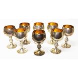 A set of eight Eizabeth II silver goblets with gilt interiors, cast knopped stem and domed feet,