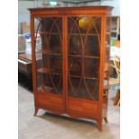 An Edwardian satin wood and mahogany display cabinet, width 130cm, depth 37cm & height 184.5cm.