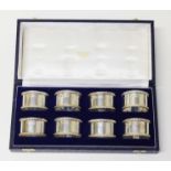 A Elizabeth II cased set of eight silver serviette rings, J B Chatterley & Sons Ltd, Birmingham