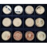 A collection of twelve Silver Proof Commemorative crowns in capsules, with certificates and in a