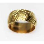 An 18ct gold wedding band, engraved with flowers, sponsor's mark 'S&W', London 1968, wt. 8.2g,