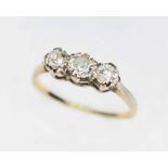 A three stone diamond ring, the diamonds weighing approx. 0.23, 0.25 & 0.20 carats, band marked '