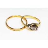 A hallmarked 22ct gold wedding band wt. 1.5g and a hallmarked 18ct gold three stone diamond ring wt.