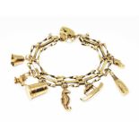 A 9ct gold charm bracelet, six hallmarked 9ct gold charms and another unmarked, gross wt. 12.9g.