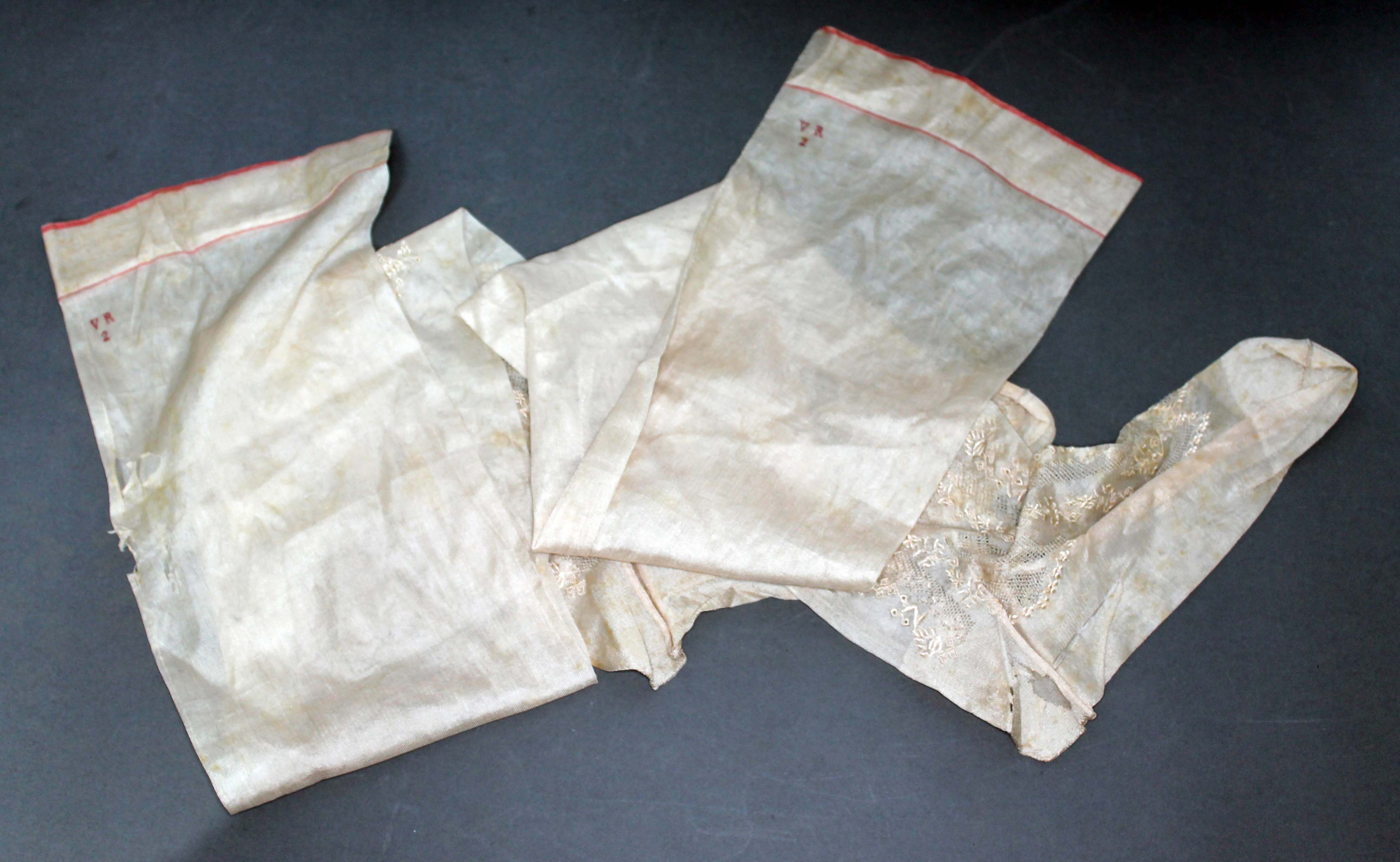 A pair of Silk stockings reputedly once belonging to Queen Victoria, monogrammed 'VR2' above a