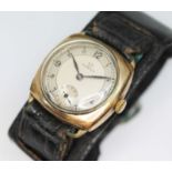 A 1934 Omega gold plated trench type watch, signed two colour dial with Arabic numerals and