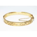 A hallmarked 9ct gold bangle, diameter approx. 5.5cm, wt. 13.1g. Condition - various dings, mainly