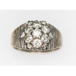 A diamond cluster ring, total approx. diamond wt. 0.82cts (estimated while set), white metal band