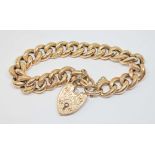 An early 20th century half engraved link bracelet with heart shaped pad lock clasp, maker's mark '