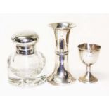 Three items of silver comprising a glass jar, egg cup and a vase.