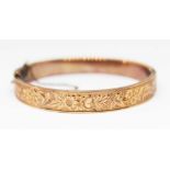 An Edwardian engraved 9ct gold bangle, sponsor's mark 'A.I', Birmingham 1903, diam. approx. 55mm,