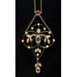 An Edwardian pink tourmaline, seed pearl and aquamarine pendant of typical form with central