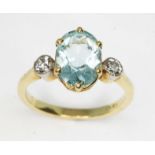 An aquamarine and diamond ring, the central six claw set oval cut stone weighing approx. 1.77ct,