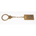 A key fob, the drop modelled as a ten pound note, 9ct gold import marks, length 10cm, wt. 6.9g.