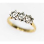 A three stone diamond ring, the round brilliant diamonds weighing approx. 0.90ct in total,