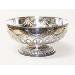 A Victorian silver punch bowl, embossed with swags and bows, gadrooned, pedestal foot, inscribed '