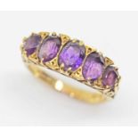 A five stone amethyst ring, scroll setting, hallmarked 18ct gold, sponsor's mark 'AJW', London 1967,